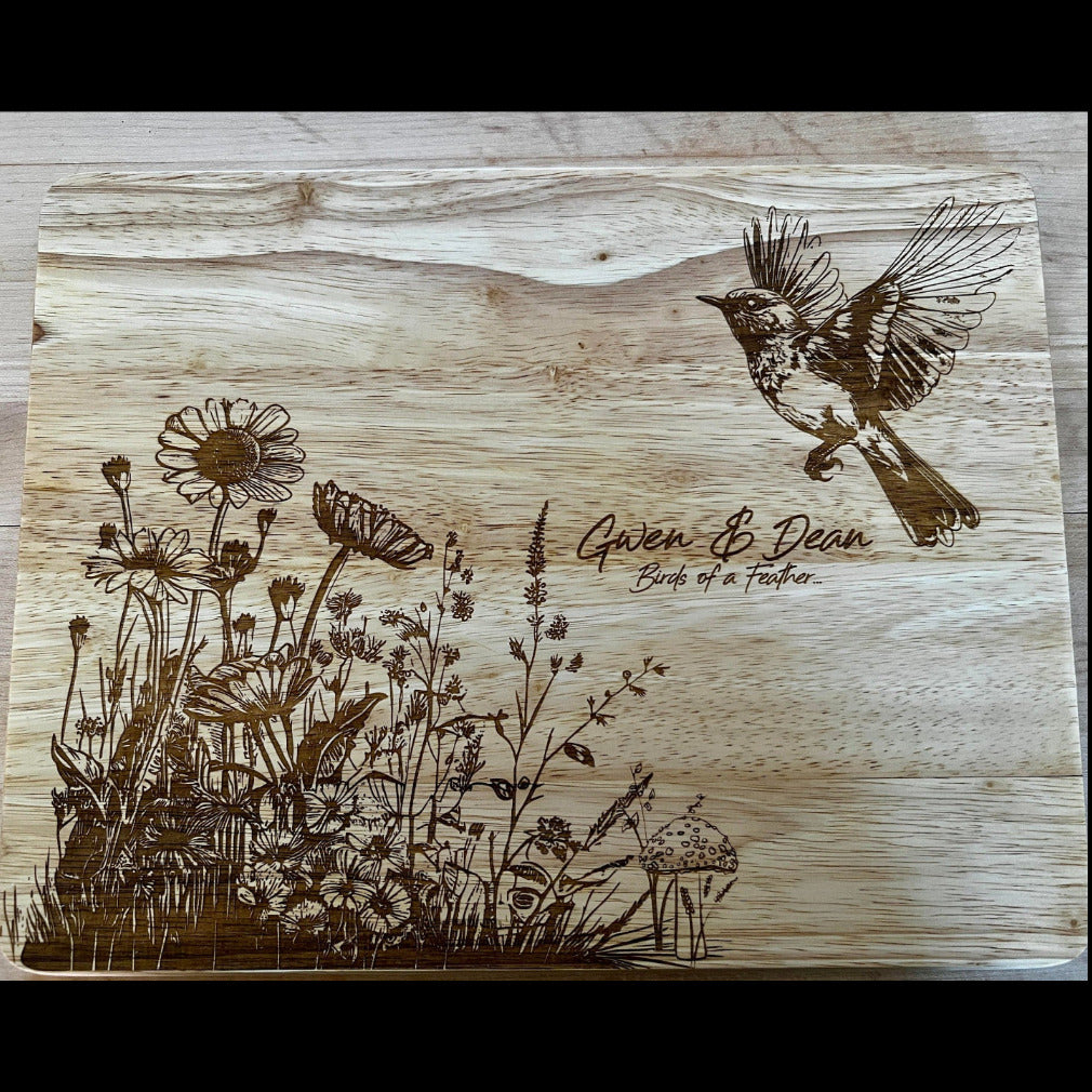 Custom engraved wedding cutting board with bird and floral design, names, and wedding date by Finger Lakes Laser.